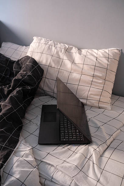 istock A Cozy Workspace Featuring a Laptop Positioned Comfortably on a Bed with Soft Pillows 2239958784