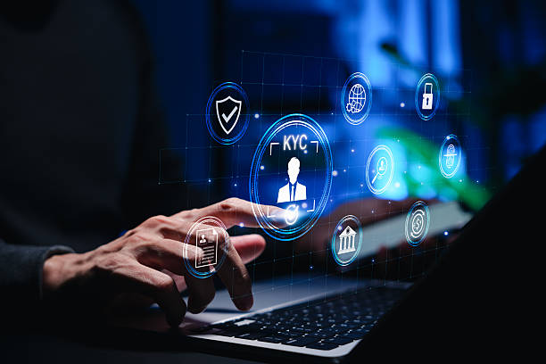 istock Businessman using laptop with digital KYC interface and identity verification icons. Concept of cybersecurity, online banking, secure authentication, and digital customer onboarding in fintech systems, E-KYC 2239962545