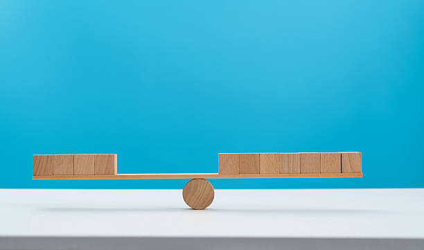 istock Blank cubes on wooden seesaw 2239963366
