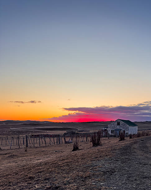 istock Wooden barn on a ranch on the prairie in a dramatic sunrise 2239963518