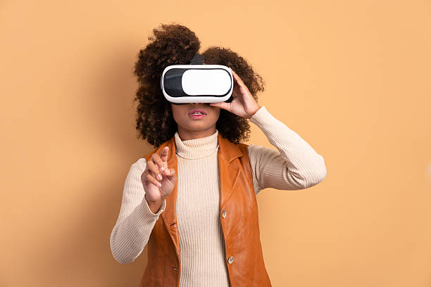 istock curious african american woman Using VR headset and gesturing in studio shot. virtual reality, technology simulation concept. 2239963618