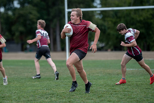 istock Young Rugby Players Sprint Across Field With Ball During Fast-Paced Team Practice 2239964245