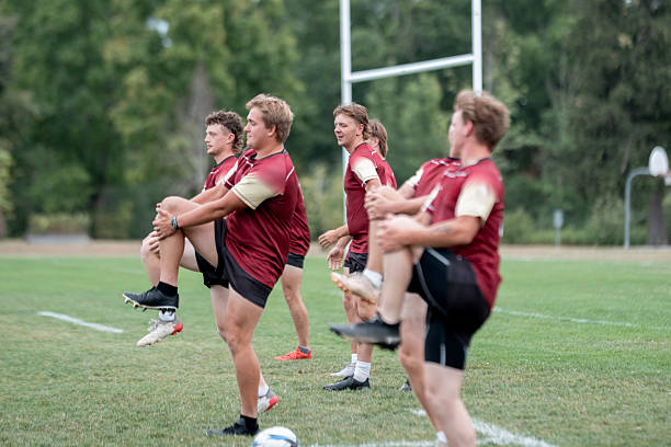 istock Rugby Team Warm-Up On Field: Athletic Players Stretching Together Before Training 2239964247