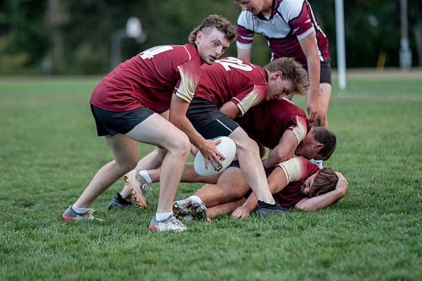 istock Rugby Team Collapses in a Scrum on Green Field During a Competitive Match, Sunlit Afternoon 2239964304