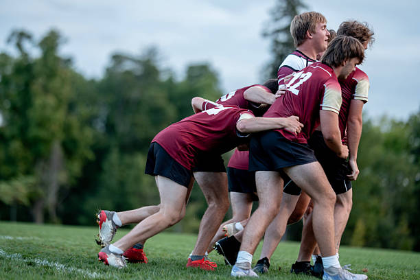 istock Team Rugby Players Huddle On Grass Field During Outdoor Practice Showcasing Unity And Sportiness 2239964337
