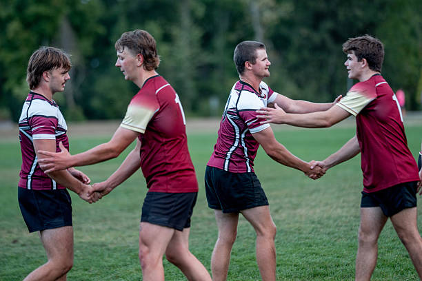 istock Rugby Players Shake Hands and Celebrate on a Green Field After a Match 2239964355