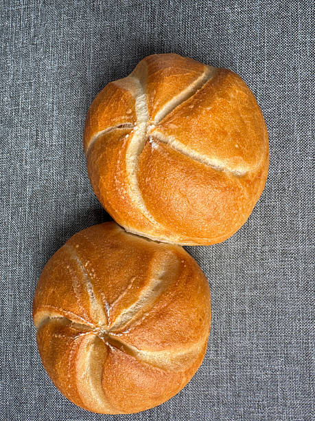 istock Two golden Kaiser rolls on linen background, top view bakery mockup with copy space 2239967831
