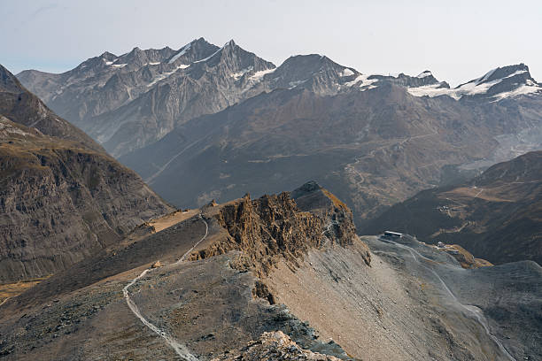 Snow-covered Alps mountain range with clouds, seen from Zermatt, Switzerland