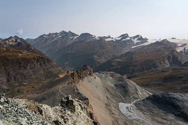 Snow-covered Alps mountain range with clouds, seen from Zermatt, Switzerland