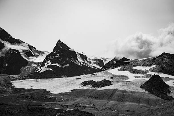 istock Snow-covered Alps mountain range with clouds, seen from Zermatt, Switzerland 2239970369