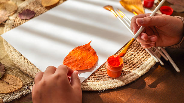 istock Autumn art project with leaf and paint 2239971520