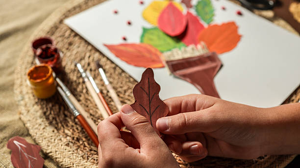 istock Autumn art project with colorful leaves and paint 2239971550