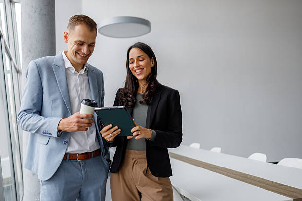 istock Business colleagues discussing project ideas using a digital tablet during a coffee break in a modern office 2239971931