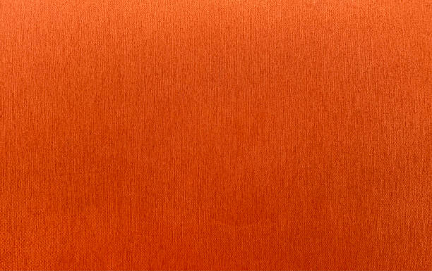 istock Vibrant, orange-red fabric with a subtle vertical weave texture. This high-quality, seamless textile background is perfect for creative projects, upholstery. 2239972478