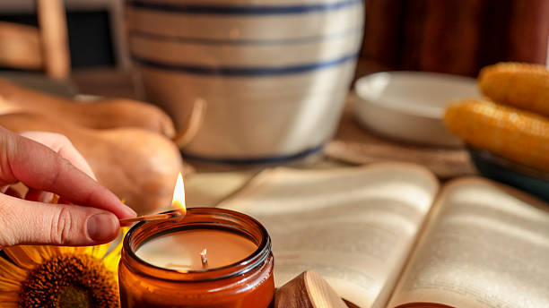 istock Cozy autumn scene with candle, book, and corn 2239972869