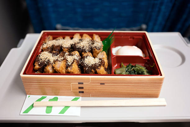 Pork cutlets topped with hatcho miso and ground sesame seeds, served with rice.\nAccompanied by pickled takana greens and a soft-boiled egg.\nEaten aboard the Shinkansen.\nA station bento sold at the station.\nIncludes disposable chopsticks and a wet wipe.