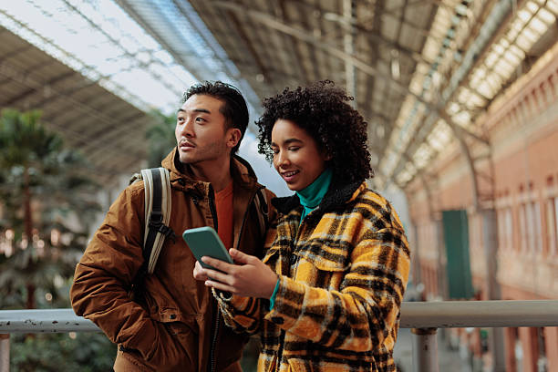 istock Young tourists using mobile phone in train station, madrid 2239974526