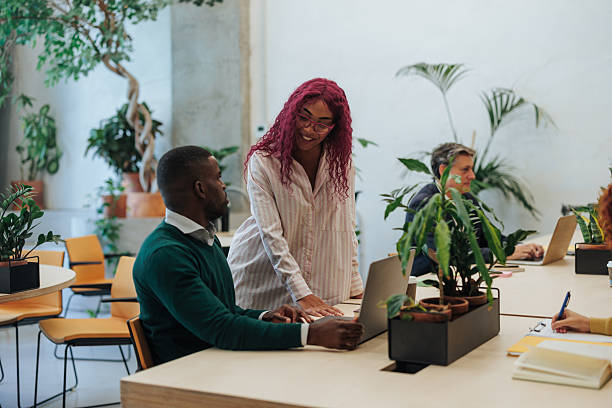 istock Colleagues collaborating on laptop in modern green office 2239974540