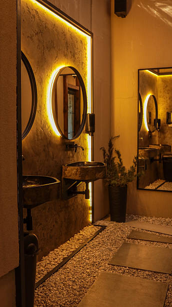 istock Stylish and modern bathroom interior with unique design elements and warm lighting. 2239974657