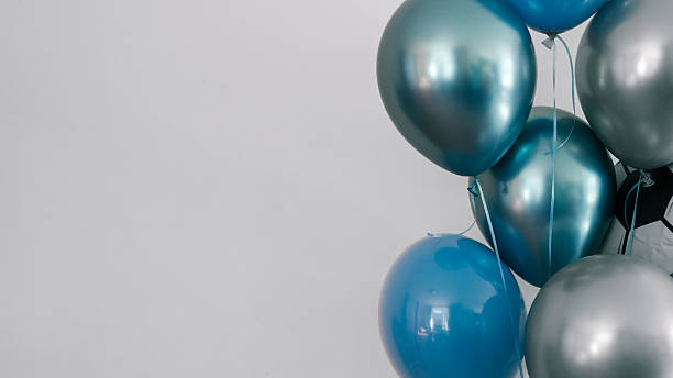 istock Blue and silver balloons against a white background 2239974659