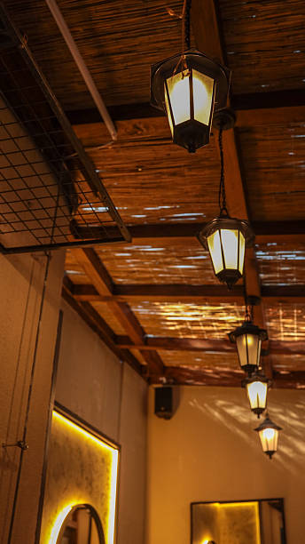 Elegant lanterns illuminate a cozy interior with a warm, inviting ambiance.