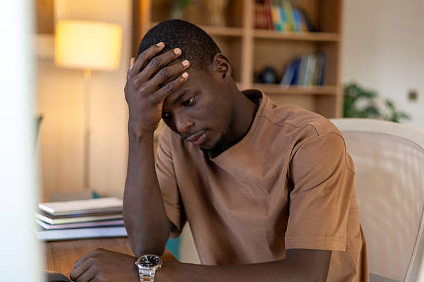 istock Young black man suffering from stress and burnout at home office desk 2239976137
