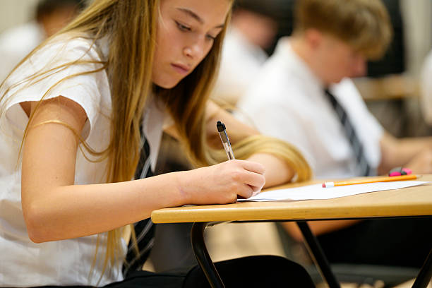 istock Secondary school children sitting at desk during exam 2239976434