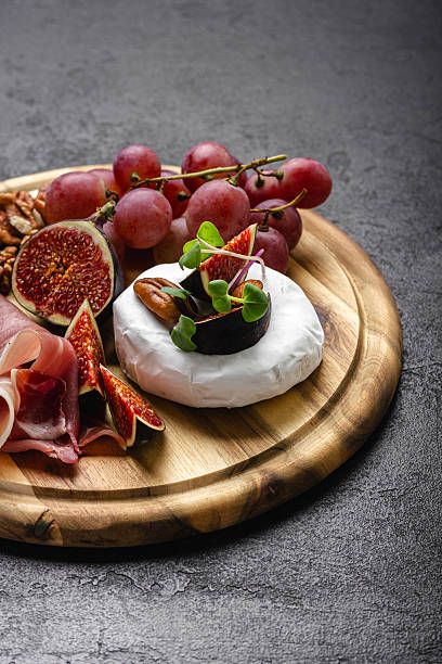 istock Appetizer board with meat, cheese, grapes, nuts and fresh figs. 2239977807