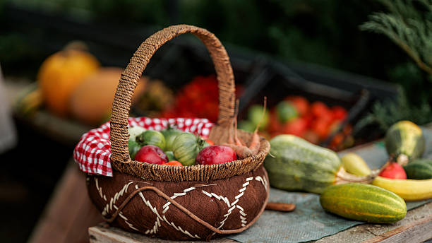 istock Basket of fresh vegetables on a wooden surface 2239978068