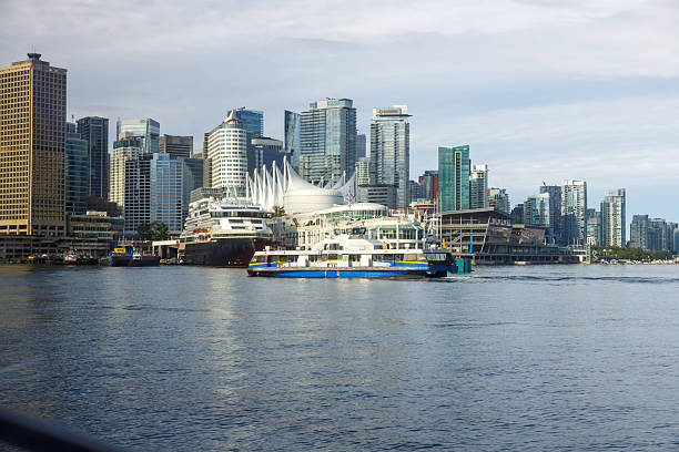 Vancouver, Canada -Sep 25,2025: Dynamic SeaBus ferry navigating Burrard Inlet towards Vancouver's iconic skyline