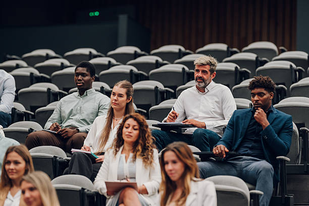istock Diverse audience attentively learning at business seminar 2239980015