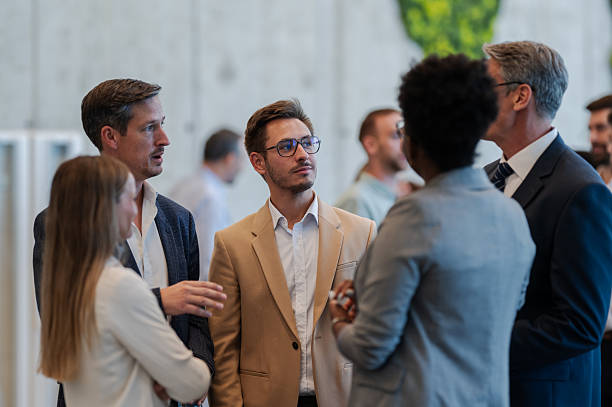 istock Business professionals networking at conference event 2239980221