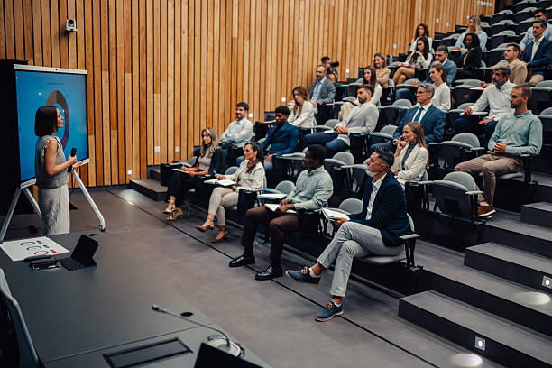 istock Businesswoman presenting financial data to a diverse audience 2239980935