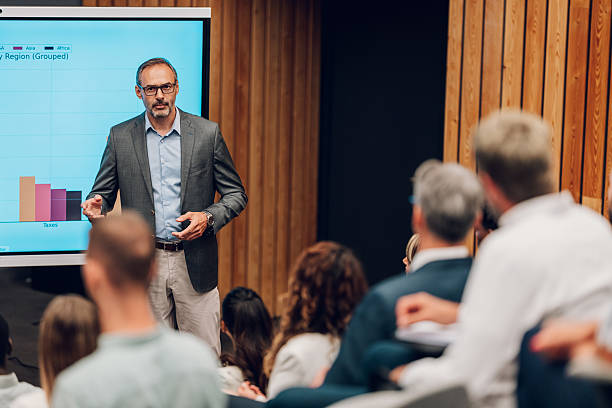 istock Speaker presenting business data to audience at conference 2239980967