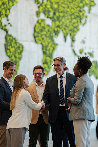 istock Business people having handshake meeting with world map 2239981044