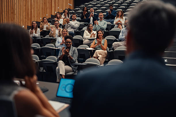 istock Business people applauding presentation at diversity conference 2239981139