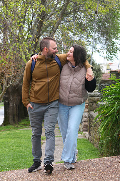 istock Happy   couple walking together outdoors in spring or autumn. 2239985899