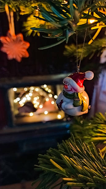 istock Snowman ornament on Christmas tree with chimney background 2239986281