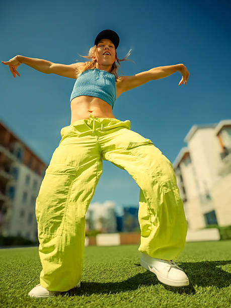 istock Woman dancing on grass lawn 2239988074