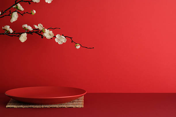 istock Minimalist red plate on bamboo mat with white cherry blossoms. Elegant Japanese style composition 2239989018