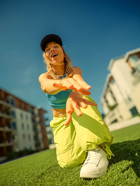 istock Woman dancing on grass lawn 2239989408