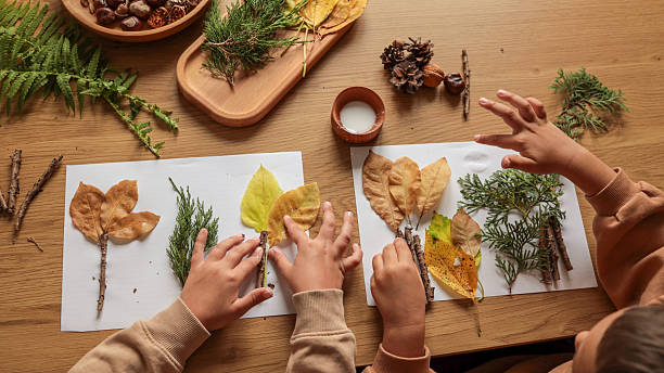 istock Child's Autumn Craft Project with Leaves and Twigs 2239989657