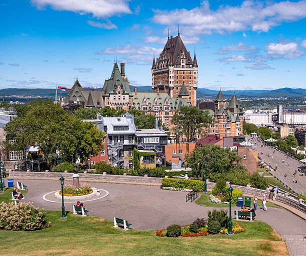 As viewed from a park overlooking the focal point of Quebec City, the Fairmont Chateau Frontenac Hotel is a historic hotel within the historic district's Upper Town, on the southern side of Place d'Armes. The Château Frontenac was designed by New York architect Bruce Price in the Château style. It was built by the Canadian Pacific Railway company. The hotel is managed by Fairmont Hotels & Resorts. It is considered the most photographed hotel in the world.Opened in 1893, it was one of the first of Canada's grand railway hotels, and was designated a National Historic Site of Canada in 1981. The hotel was expanded on three occasions, with the last major expansion taking place in 1993.