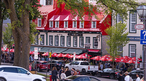 Tourists crowd the sidewalk in front of Viandes & Vin Bistro 1640 restaurant on Rue Sainte-Anne in the Old Town section of Quebec City on a busy August 2025 afternoon.