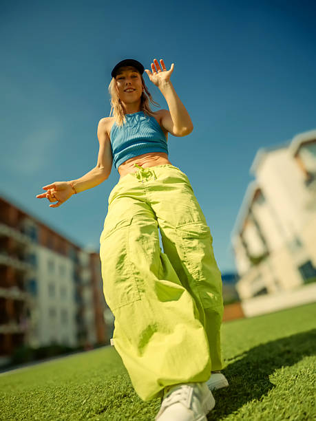 istock Woman dancing on grass lawn 2239990524