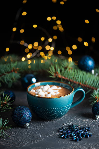 istock Hot Chocolate with Marshmallows in Teal Mug Surrounded by Christmas Decor 2239991706