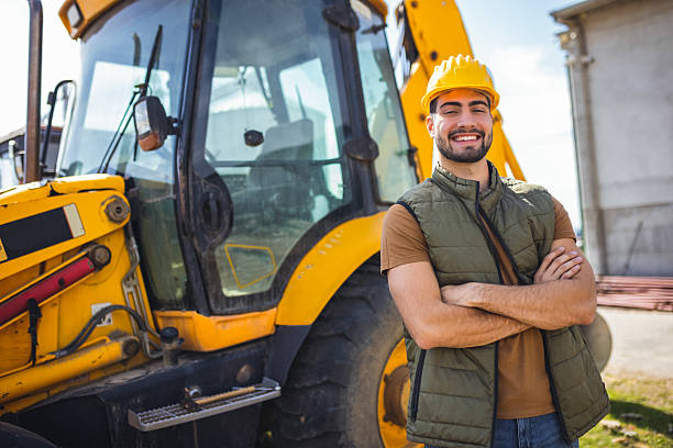 Cheerful positive handsome senior engineer with helmet satisfied with construction plan