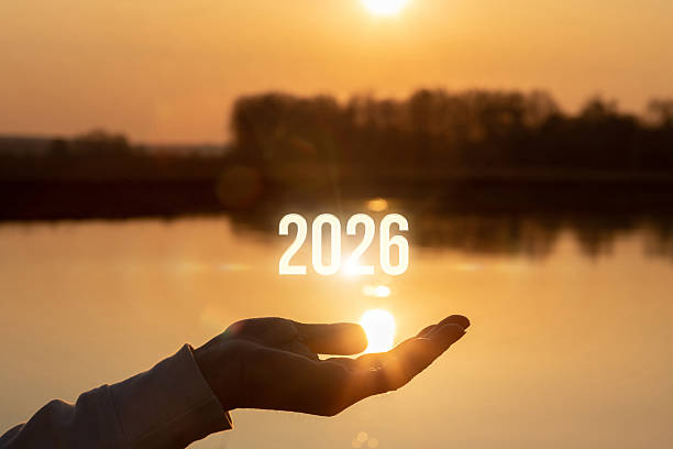 Future hope held in hand over sunset water view.