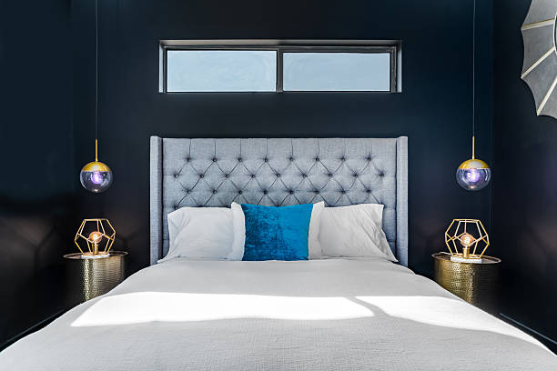 istock Modern bedroom interior gray headboard, bed, pillows, black walls 2239992908