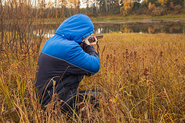 Duck hunting . A man with a gun on a duck hunt.